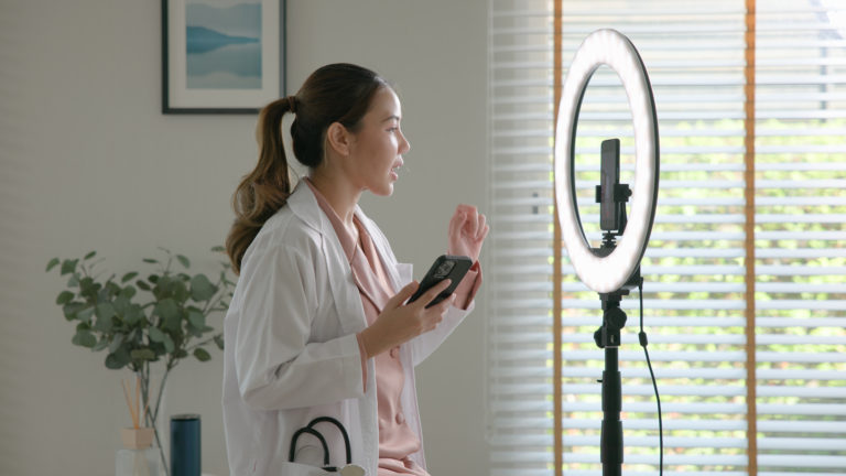 Médica gravando uma live para divulgar a sua clínica