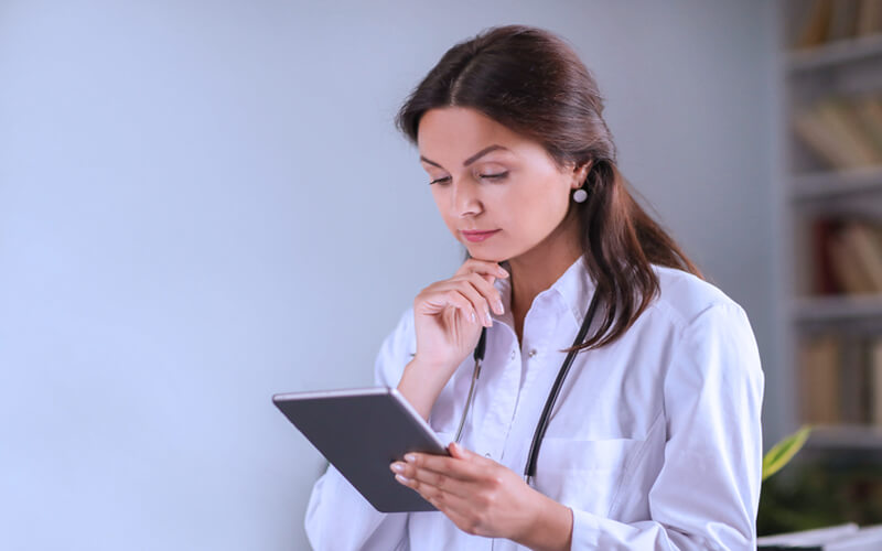 Auditoria médica: por que é importante aplicar na sua clínica? 6 auditoria medica medica analisando tablet