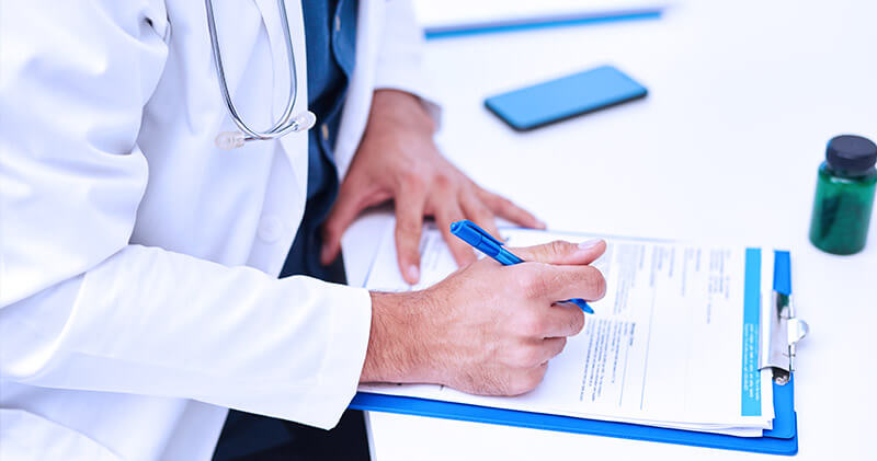 medico escrevendo auditoria de prontuario