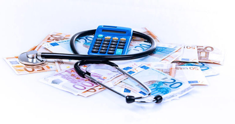 tributacao para medicos calculadora e dinheiro sobre a mesa